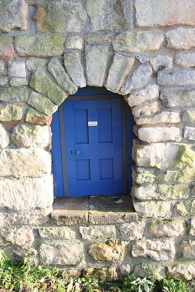 Diminutive doorway. A tiny doorway, 18inches high, in an ancient wall on Motherby Hill. The notice on the door says: 