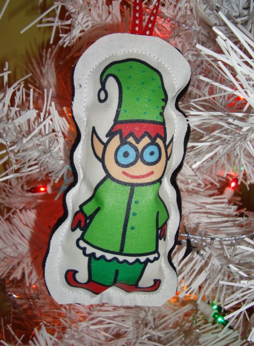 A diminutive Christmas elf on a Christmas tree decoration. Originally posted on Flickr. Author: Jolene Morris. Commons