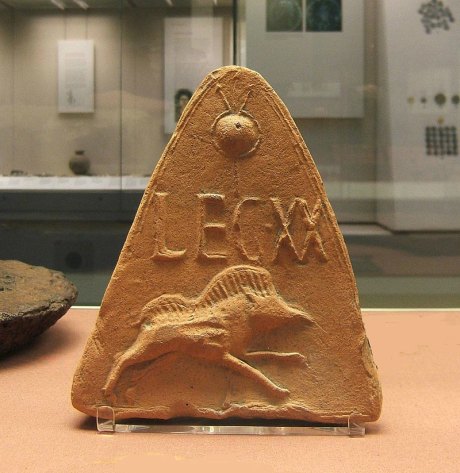 Moulded antefix roof tile showing badge and standard of the Lefion XX - from Holt, Clwed, Wales. Author: AgTigress. Creative Commons